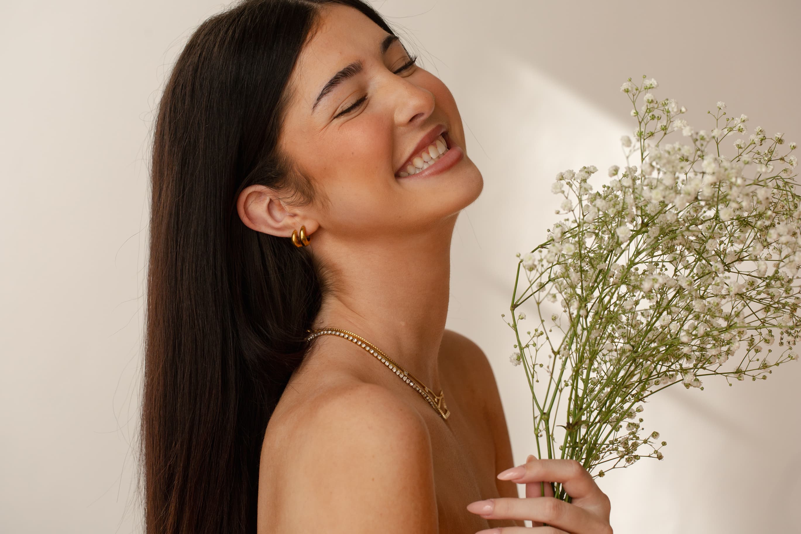 Model smiling with flowers